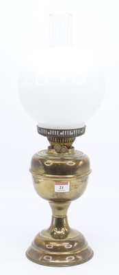 Lot 21 - A Victorian brass oil lamp, the milk glass...