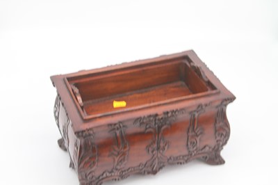 Lot 36 - A modern carved hardwood casket, with fitted...