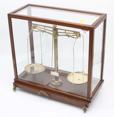 Lot 54 - A set of brass balance scales in a glazed case,...
