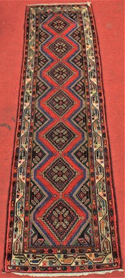 Lot 2697 - A Persian woollen hall runner, the central...