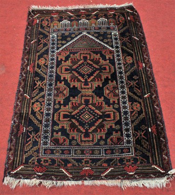 Lot 2662 - A Persian woollen prayer rug, the blue ground...