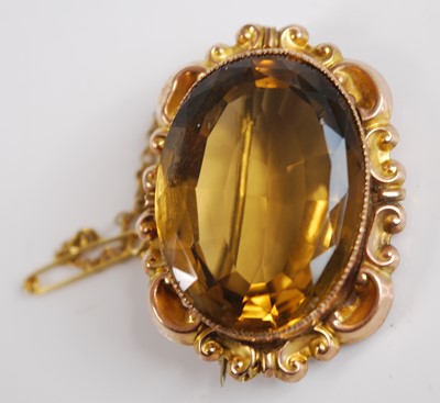 Lot 2550 - A yellow metal citrine brooch, the oval...