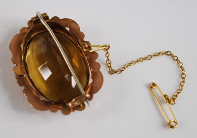 Lot 2550 - A yellow metal citrine brooch, the oval...