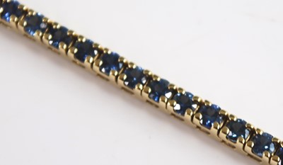 Lot 2551 - A yellow metal sapphire line bracelet...
