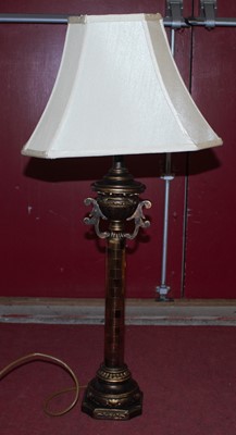 Lot 254 - A modern gilt table lamp, having a cream shade,...