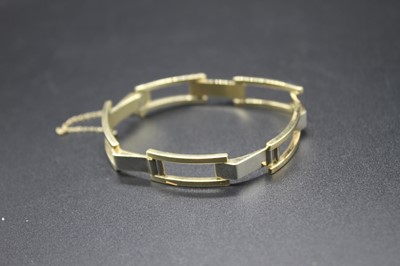 Lot 416 - A continental yellow metal gatelink bracelet,...