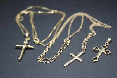 Lot 429 - A modern 9ct gold cross pendant, on finelink...