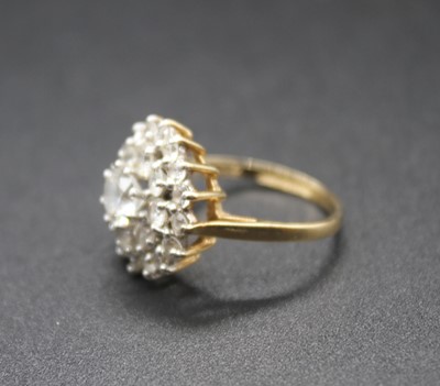 Lot 437 - A modern 9ct gold and cz set cluster ring,...