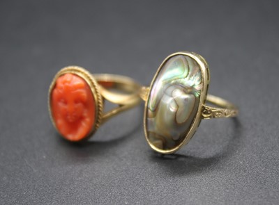 Lot 438 - An 18ct gold carved coral set ring, 3.9g, size...