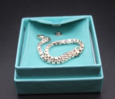 Lot 473 - A Tiffany & Co silver bracelet, 19cm, together...