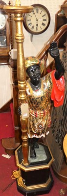 Lot 1168 - A carved, painted and gilt decorated figural...