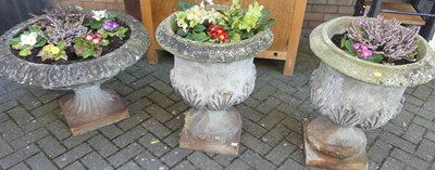 Lot 1208 - A pair of reconstituted stone pedestal urn...