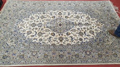 Lot 1220 - A Persian woollen cream ground Tabriz rug, 310...