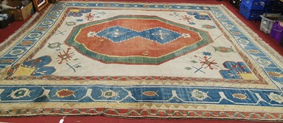 Lot 1221 - A large Turkish woollen cream ground carpet,...