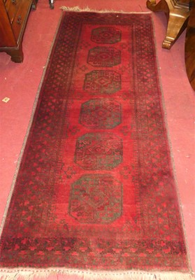 Lot 1222 - A Persian woolllen red ground Bokhara hall...