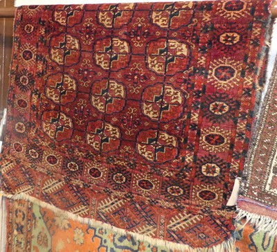 Lot 1226 - A Persian woollen red ground Bokhara rug...