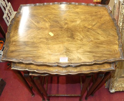 Lot 1255 - A walnut nest of three occasional tables, the...