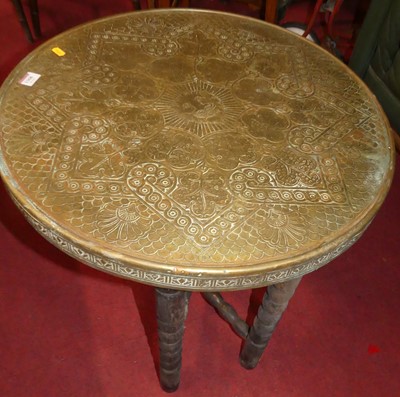 Lot 1368 - A brass topped Benares table on folding base,...