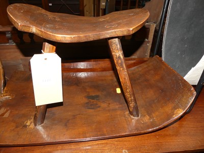 Lot 1440 - A stained softwood milking stool