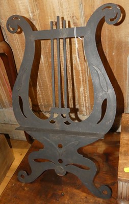 Lot 1454 - A black painted pierced steel table-top music...