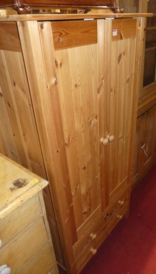 Lot 1464 - A modern pine child's double door wardrobe,...