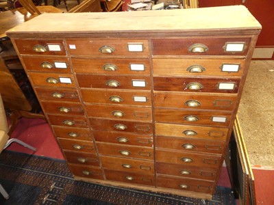 Lot 1507 - A rustic walnut freestanding bank of drawers,...