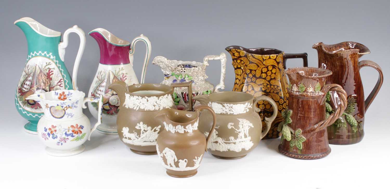 Lot 4071 - A collection of nine Victorian pottery jugs,...
