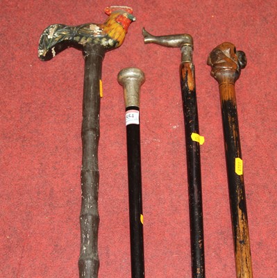 Lot 554 - Four walking sticks, to include a silver...