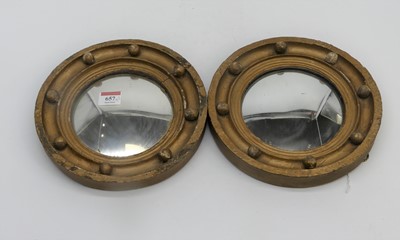 Lot 657 - Two porthole style mirrors with gilt decoration