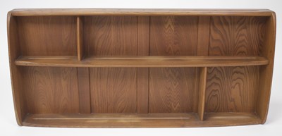 Lot 457 - An Ercol light elm sectional open hanging...