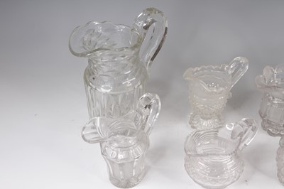 Lot 4096 - A collection of eight cut glass jugs, 19th...