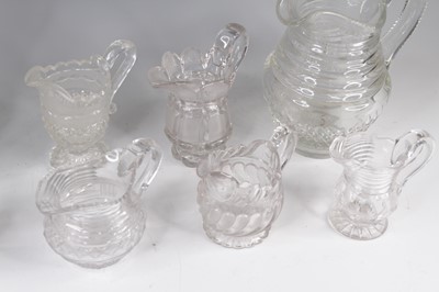 Lot 4096 - A collection of eight cut glass jugs, 19th...