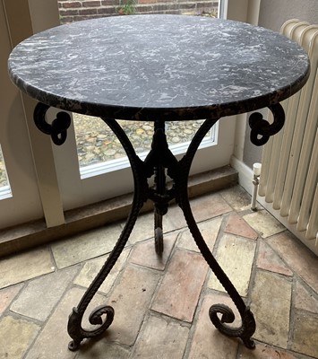 Lot 4550 - A cast iron and black variegated marble topped...