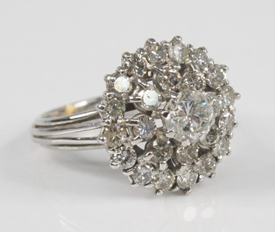 Lot 2401 - A white metal diamond circular cluster ring,...