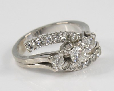 Lot 2386 - A white metal diamond crossover ring, having...