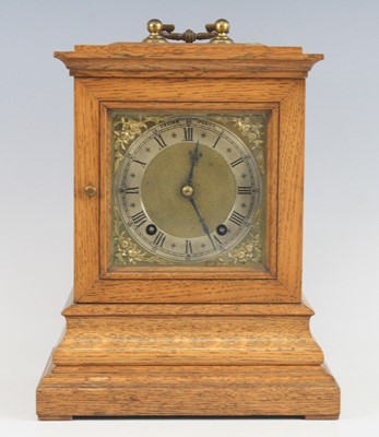 Lot 2650 - An Edwardian oak three-glass mantel clock, the...