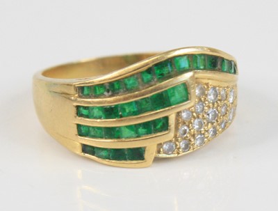 Lot 2354 - A modern emerald and diamond half-hoop...