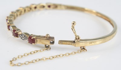 Lot 2515 - A 9ct yellow gold, ruby and diamond hinged...
