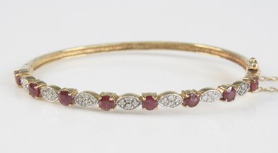 Lot 2515 - A 9ct yellow gold, ruby and diamond hinged...