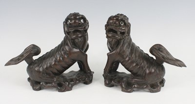 Lot 2552 - A pair of Chinese carved hardwood Fo dogs,...