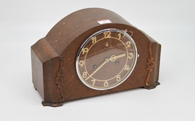 Lot 51 - A 1930s oak cased mantel clock, having...