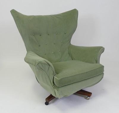 Lot 502 - A 1960s upholstered winged swivel armchair,...