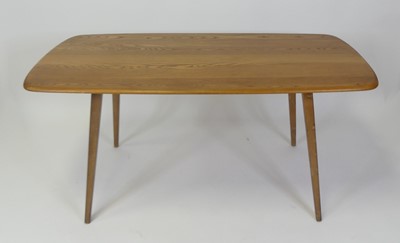 Lot 450 - A 1960s Ercol blond elm dining table, having...