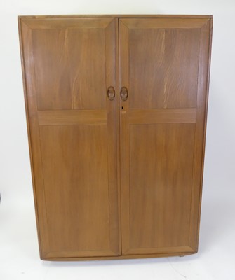 Lot 460 - An Ercol light elm double door compactum...