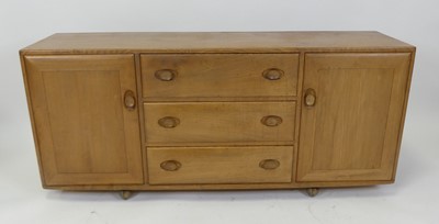 Lot 458 - An Ercol blond elm Windsor sideboard, having...