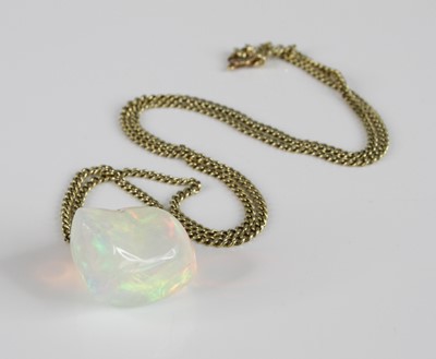 Lot 2332 - A polished opal pendant, of irregular...