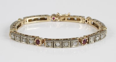 Lot 2409 - A yellow metal, ruby and diamond set tennis...