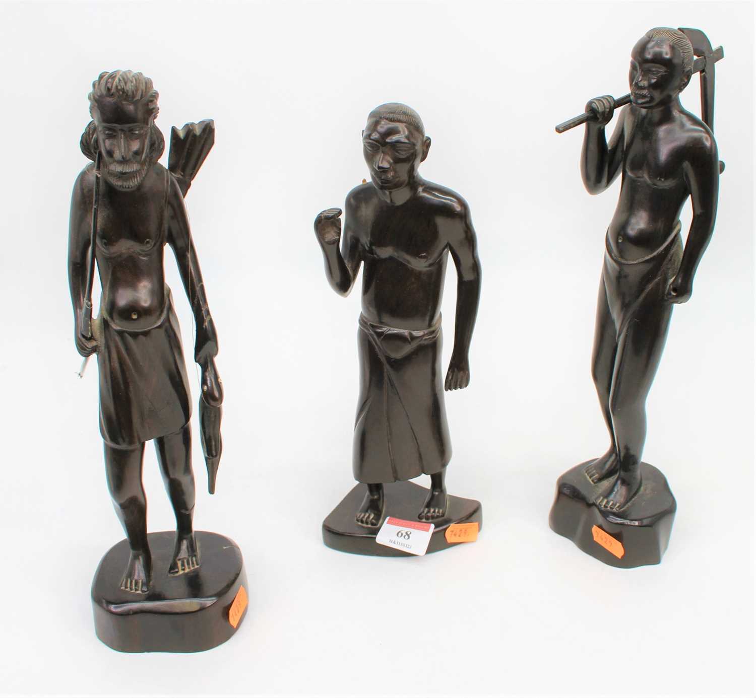 Lot 68 - A set of three African carved hardwood figures,...
