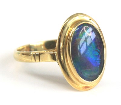 Lot 2518 - A yellow metal opal triplet ring, the black...