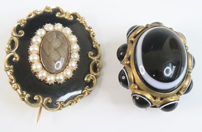 Lot 4142 - Two brooches, being a yellow metal oval...